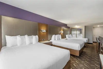 two beds in a hotel room with white sheets at Best Western Airport Plaza Hotel – LAX Airport LA Stadium in Los Angeles