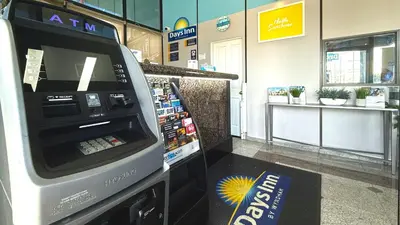 an atm machine in a store with a book at Days Inn by Wyndham Los Angeles LAX Airport Stadium Area in Los Angeles