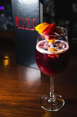 a drink with a strawberry and an orange slice in a glass at E Central Hotel Downtown Los Angeles in Los Angeles