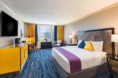 a hotel room with a large bed and a desk at E Central Hotel Downtown Los Angeles in Los Angeles
