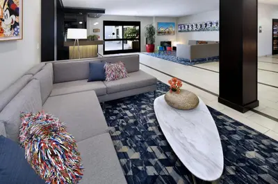 a living room with a couch and a table at Holiday Inn Hotel & Suites Anaheim by IHG in Anaheim