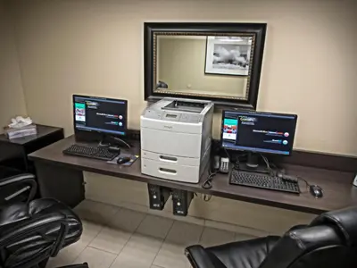a desk with two monitors and a computer on it at Holiday Inn Hotel & Suites Anaheim by IHG in Anaheim