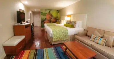 a hotel room with a bed and a couch at Hotel Indigo Anaheim by IHG in Anaheim