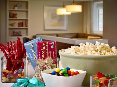 a table with popcorn and candy and bowls of popcorn at Sonesta ES Suites Anaheim Resort Area in Anaheim