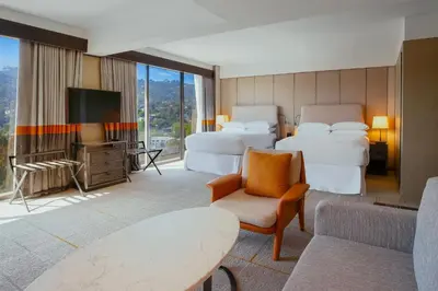 a hotel room with two beds and a tv at Sheraton Universal in Los Angeles