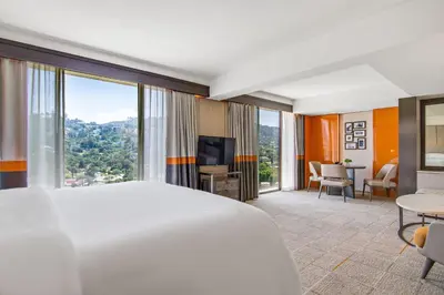 a hotel room with a bed and a large window at Sheraton Universal in Los Angeles