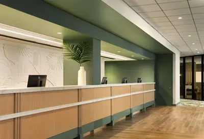 a waiting room with a potted plant on the wall at Sonesta Los Angeles Airport LAX in Los Angeles