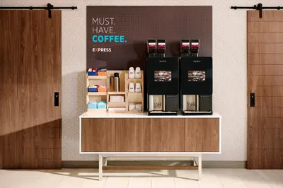 a coffee shop with a counter with a coffee maker on it at Holiday Inn Express Los Angeles LAX Airport by IHG in Los Angeles