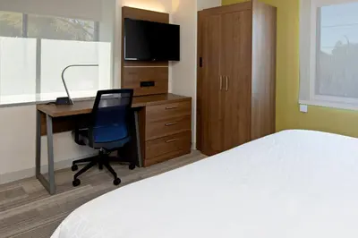 a bedroom with a bed and a desk with a computer at Holiday Inn Express Los Angeles LAX Airport by IHG in Los Angeles