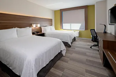 a hotel room with two beds and a flat screen tv at Holiday Inn Express Los Angeles LAX Airport by IHG in Los Angeles