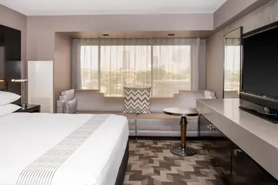 a hotel room with a bed and a couch and a television at Beverly Hills Marriott in Los Angeles