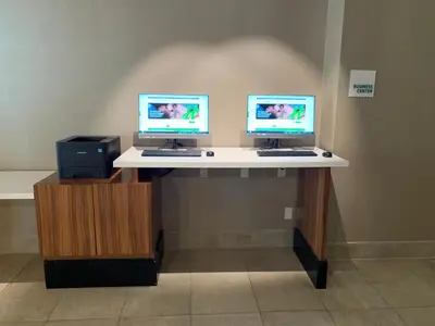 two computer monitors on a desk in a room at Holiday Inn Los Angeles - LAX Airport by IHG in Los Angeles