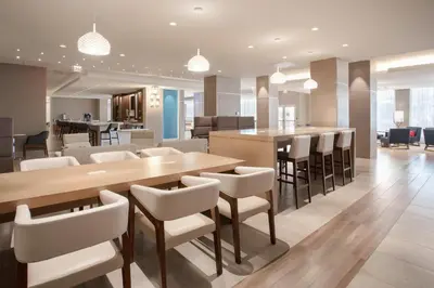 a dining room with a table and chairs at Holiday Inn Los Angeles - LAX Airport by IHG in Los Angeles
