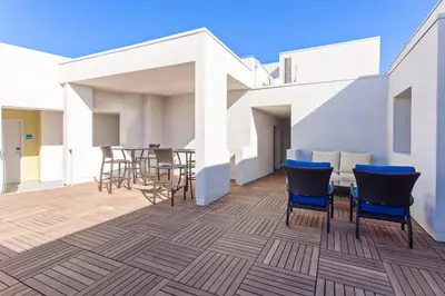 a patio with chairs and a table on a building at Holiday Inn Express West Los Angeles by IHG in Los Angeles