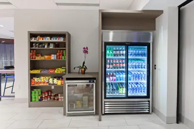 a large refrigerator in a store with drinks at Holiday Inn Express West Los Angeles by IHG in Los Angeles
