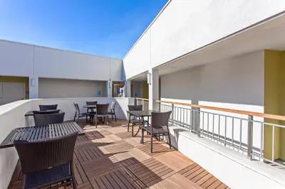 a balcony with tables and chairs on a building at Holiday Inn Express West Los Angeles by IHG in Los Angeles