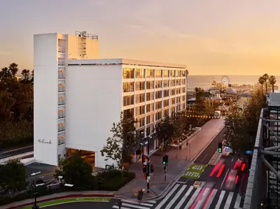 a white building on a city street with traffic at The Pierside Santa Monica in Los Angeles