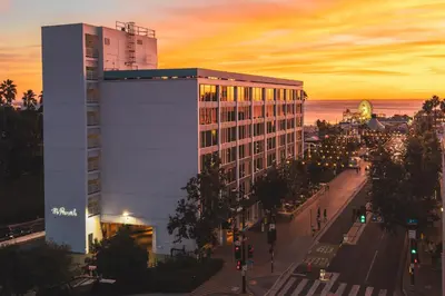 a building on a street in front of the ocean at The Pierside Santa Monica in Los Angeles
