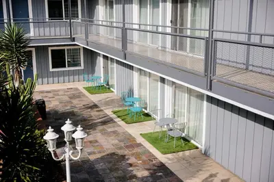 a balcony of a building with chairs and a table at The Live Hotel in Los Angeles