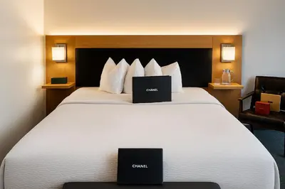 two laptops sitting on a bed in a hotel room at The Live Hotel in Los Angeles