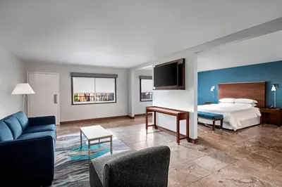 a hotel room with a bed and a tv at Four Points by Sheraton Anaheim in Anaheim