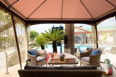a patio with a couch and chairs and a table at Four Points by Sheraton Anaheim in Anaheim