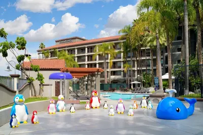 a group of rubber penguins in front of a pool at Four Points by Sheraton Anaheim in Anaheim