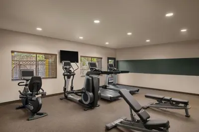 a gym with several exercise equipment in a room at Four Points by Sheraton Anaheim in Anaheim