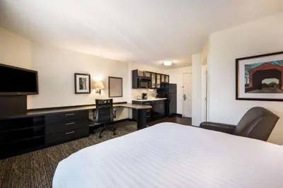 a hotel room with a bed and a desk at Sonesta Simply Suites Anaheim in Anaheim