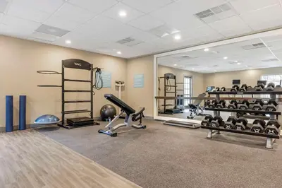 a gym with several treadmills and weights in a room at Sonesta ES Suites Torrance Redondo Beach in Torrance