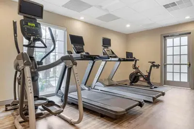 a gym with two tread machines and two exercise bikes at Sonesta ES Suites Torrance Redondo Beach in Torrance