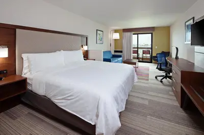 a hotel room with a large bed and a desk at Holiday Inn Express Hotel & Suites Ventura Harbor by IHG in Ventura