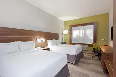 a hotel room with two beds and a desk at Holiday Inn Express & Suites Corona by IHG in Corona