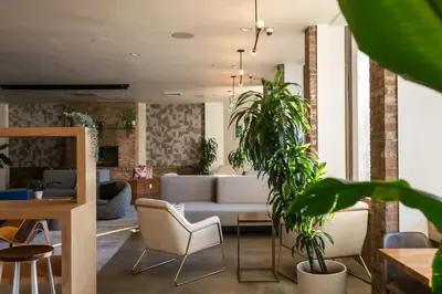 a living room with a couch and some plants at Hotel Burbank in Burbank