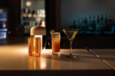a drink and a glass sitting on a table at Hotel Burbank in Burbank