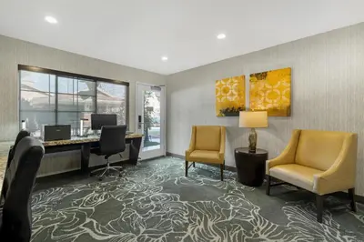 an office with a desk and two chairs and a computer at Best Western Plus Carriage Inn in Sherman Oaks