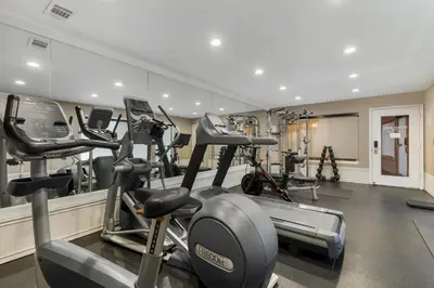 a gym with several tread machines in a room at Best Western Plus Carriage Inn in Sherman Oaks