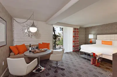 a bedroom with a bed and a table and chairs at The Garland in Los Angeles