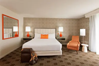 a bedroom with a large bed and two chairs at The Garland in Los Angeles