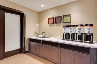 a room with a counter with bottles of wine on it at Hampton Inn & Suites Los Angeles - Glendale in Glendale