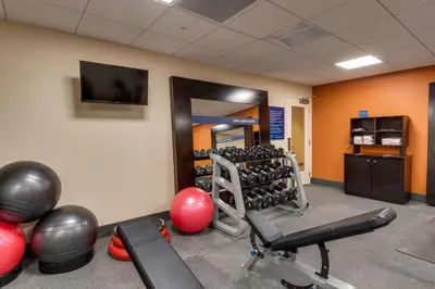 a fitness room with exercise equipment and a television at Hampton Inn & Suites Los Angeles - Glendale in Glendale