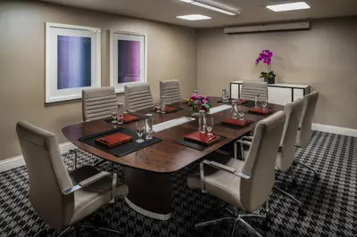 a conference room with a wooden table and chairs at The Commerce Casino & Hotel in Commerce