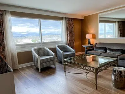 a living room with a couch and chairs and a table at The Commerce Casino & Hotel in Commerce