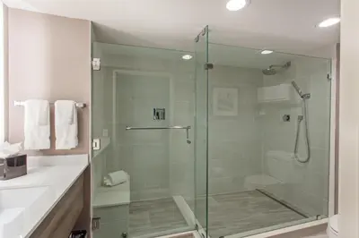 a glass shower in a bathroom with a sink at Holiday Inn Diamond Bar - Pomona by IHG in Diamond Bar