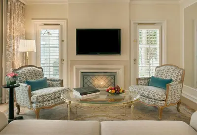 a living room with two chairs and a coffee table at The Peninsula Beverly Hills in Los Angeles