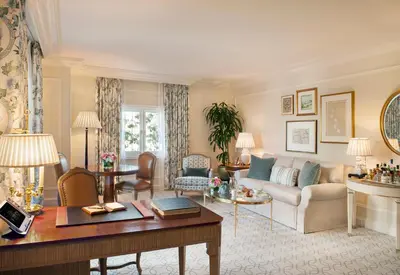 a living room with a couch and a table at The Peninsula Beverly Hills in Los Angeles