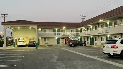 a parking lot with cars parked in front of a motel at El Segundo Inn in Hawthorne