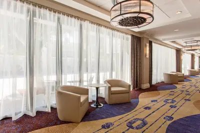 a waiting room with chairs and large windows at Holiday Inn Long Beach - Airport by IHG in Long Beach