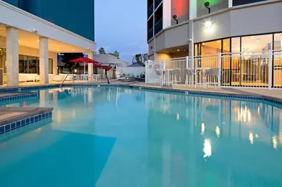 a large swimming pool in front of a building at Holiday Inn Long Beach - Airport by IHG in Long Beach