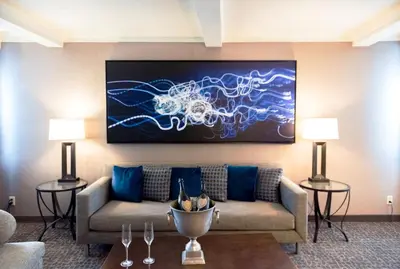 a living room with a couch and a painting on the wall at Holiday Inn Long Beach - Airport by IHG in Long Beach
